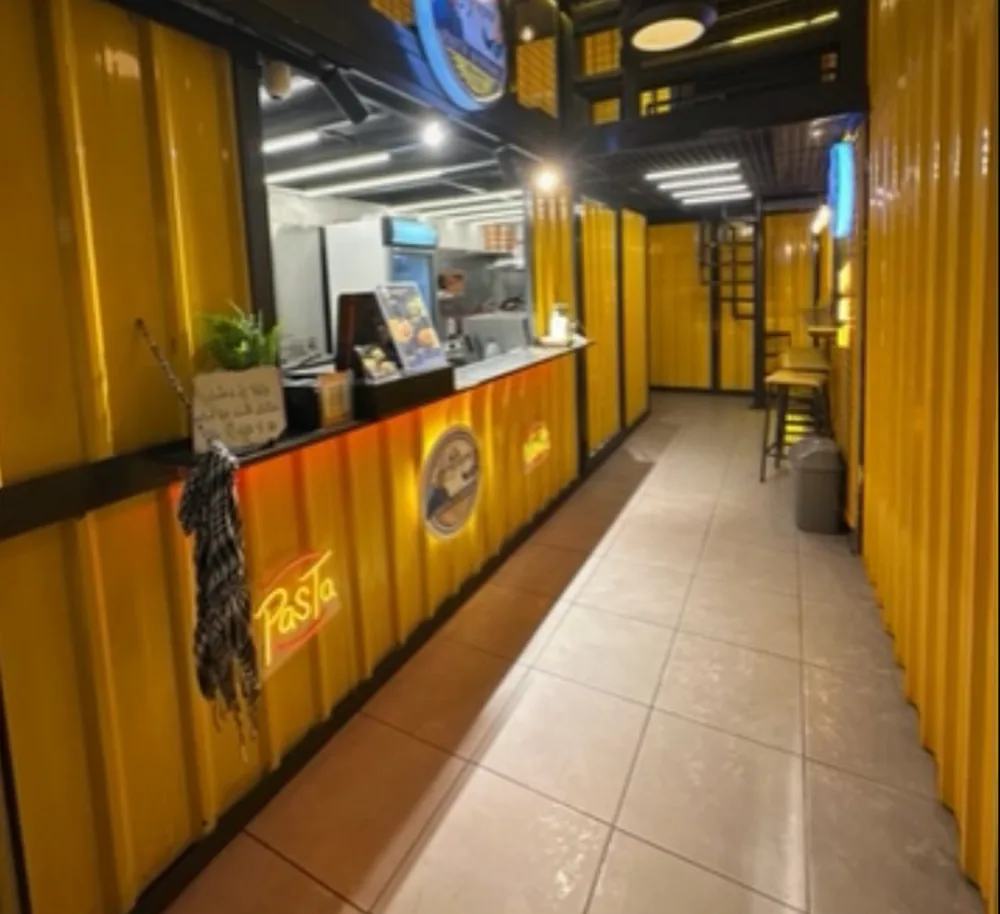 The golden container counter with the neon Pasta sign